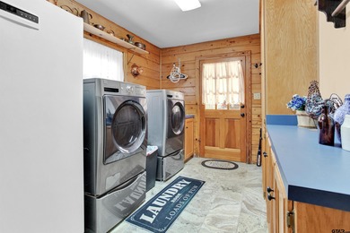 This stunning Satterwhite log home offers 2,550 square feet of on Hide-A-Way Lake Golf Course in Texas - for sale on GolfHomes.com, golf home, golf lot