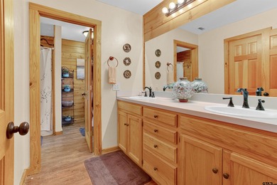 This stunning Satterwhite log home offers 2,550 square feet of on Hide-A-Way Lake Golf Course in Texas - for sale on GolfHomes.com, golf home, golf lot