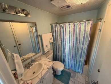 This well-cared for Palm Harbor stucco home provides beautiful on Del Tura Golf and Country Club in Florida - for sale on GolfHomes.com, golf home, golf lot