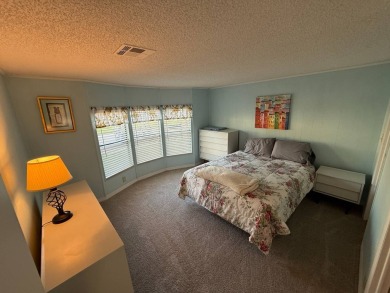 This well-cared for Palm Harbor stucco home provides beautiful on Del Tura Golf and Country Club in Florida - for sale on GolfHomes.com, golf home, golf lot