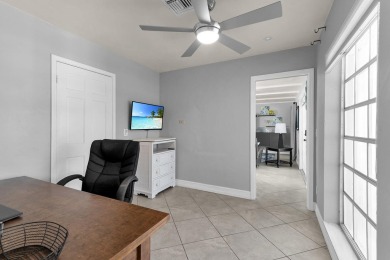 IT IS ALL ABOUT THE LOCATION. This home sits on a lake looking on Island Country Club in Florida - for sale on GolfHomes.com, golf home, golf lot