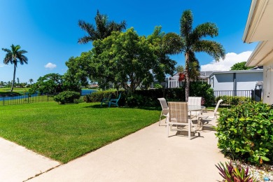 IT IS ALL ABOUT THE LOCATION. This home sits on a lake looking on Island Country Club in Florida - for sale on GolfHomes.com, golf home, golf lot