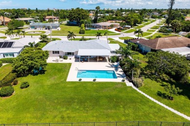 IT IS ALL ABOUT THE LOCATION. This home sits on a lake looking on Island Country Club in Florida - for sale on GolfHomes.com, golf home, golf lot