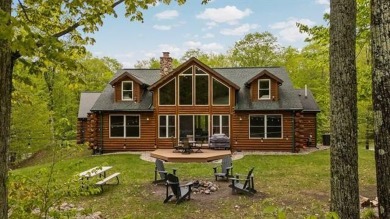 Stunning, custom-built log home overlooking the 16th tee & on Cedar River Golf Course in Michigan - for sale on GolfHomes.com, golf home, golf lot