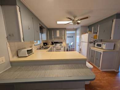 Before I forget to say it,  the GOLF CART comes with the home! on Grasslands Golf and Country Club in Florida - for sale on GolfHomes.com, golf home, golf lot