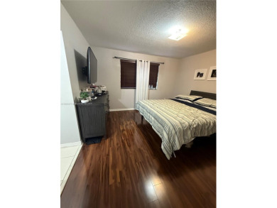 This property is a two-story unit with 3 bed 2.5 bath located in on Country Club of Miami in Florida - for sale on GolfHomes.com, golf home, golf lot