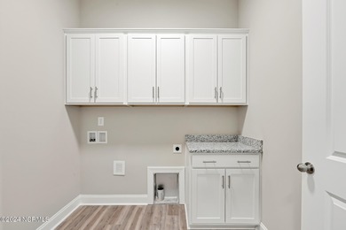 Welcome to your coastal haven, nestled among ancient oaks along on Lockwood Folly Country Club in North Carolina - for sale on GolfHomes.com, golf home, golf lot