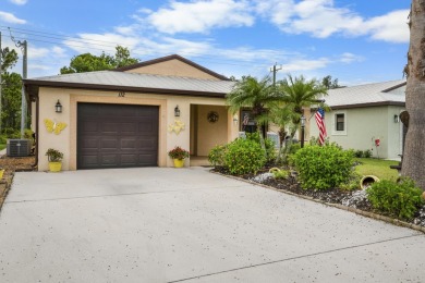 Beautiful CBC home backing to canal.  Magnificent landscaping on Spanish Lakes I in Florida - for sale on GolfHomes.com, golf home, golf lot
