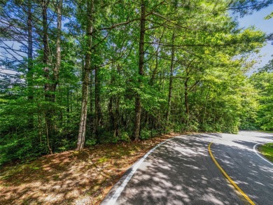 Nestled between holes 11 and 12 of Lake Toxaway Country Club's on Lake Toxaway Country Club in North Carolina - for sale on GolfHomes.com, golf home, golf lot