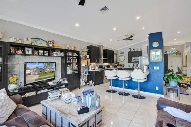 This spacious 1-story home offers serene water views from nearly on Woodmont Country Club in Florida - for sale on GolfHomes.com, golf home, golf lot