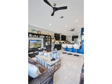 This spacious 1-story home offers serene water views from nearly on Woodmont Country Club in Florida - for sale on GolfHomes.com, golf home, golf lot