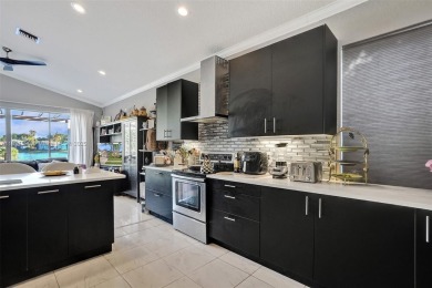 This spacious 1-story home offers serene water views from nearly on Woodmont Country Club in Florida - for sale on GolfHomes.com, golf home, golf lot