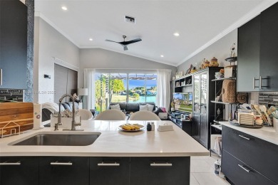 This spacious 1-story home offers serene water views from nearly on Woodmont Country Club in Florida - for sale on GolfHomes.com, golf home, golf lot