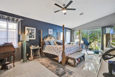 This spacious 1-story home offers serene water views from nearly on Woodmont Country Club in Florida - for sale on GolfHomes.com, golf home, golf lot