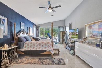 This spacious 1-story home offers serene water views from nearly on Woodmont Country Club in Florida - for sale on GolfHomes.com, golf home, golf lot
