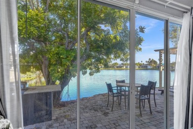 This spacious 1-story home offers serene water views from nearly on Woodmont Country Club in Florida - for sale on GolfHomes.com, golf home, golf lot