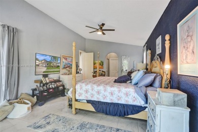 This spacious 1-story home offers serene water views from nearly on Woodmont Country Club in Florida - for sale on GolfHomes.com, golf home, golf lot