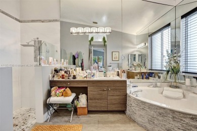 This spacious 1-story home offers serene water views from nearly on Woodmont Country Club in Florida - for sale on GolfHomes.com, golf home, golf lot