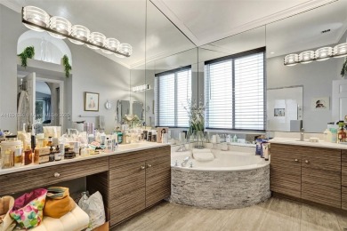 This spacious 1-story home offers serene water views from nearly on Woodmont Country Club in Florida - for sale on GolfHomes.com, golf home, golf lot
