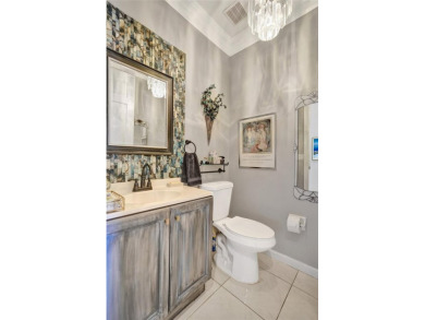 This spacious 1-story home offers serene water views from nearly on Woodmont Country Club in Florida - for sale on GolfHomes.com, golf home, golf lot