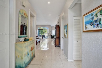 This spacious 1-story home offers serene water views from nearly on Woodmont Country Club in Florida - for sale on GolfHomes.com, golf home, golf lot