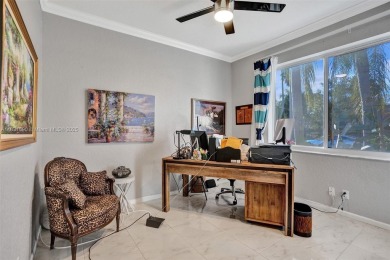 This spacious 1-story home offers serene water views from nearly on Woodmont Country Club in Florida - for sale on GolfHomes.com, golf home, golf lot