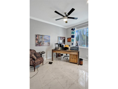 This spacious 1-story home offers serene water views from nearly on Woodmont Country Club in Florida - for sale on GolfHomes.com, golf home, golf lot