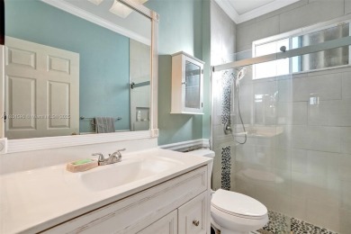 This spacious 1-story home offers serene water views from nearly on Woodmont Country Club in Florida - for sale on GolfHomes.com, golf home, golf lot