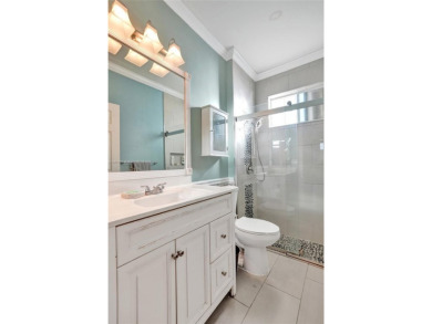 This spacious 1-story home offers serene water views from nearly on Woodmont Country Club in Florida - for sale on GolfHomes.com, golf home, golf lot
