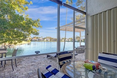 This spacious 1-story home offers serene water views from nearly on Woodmont Country Club in Florida - for sale on GolfHomes.com, golf home, golf lot