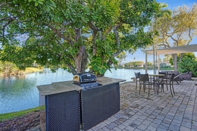 This spacious 1-story home offers serene water views from nearly on Woodmont Country Club in Florida - for sale on GolfHomes.com, golf home, golf lot