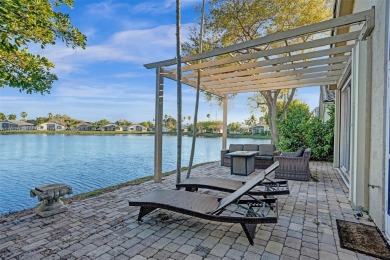 This spacious 1-story home offers serene water views from nearly on Woodmont Country Club in Florida - for sale on GolfHomes.com, golf home, golf lot