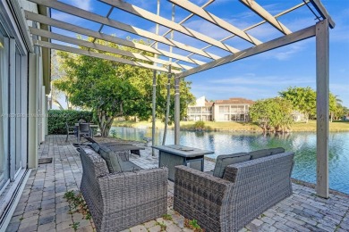 This spacious 1-story home offers serene water views from nearly on Woodmont Country Club in Florida - for sale on GolfHomes.com, golf home, golf lot