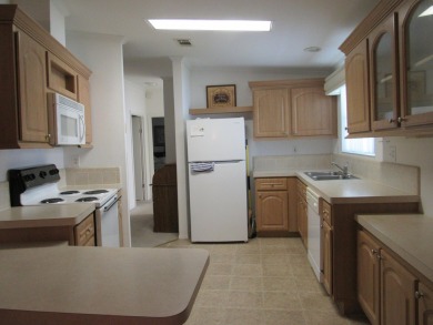 2005 Palm Harbor mobile home with a large (12x20) Florida room on Spanish Lakes Golf Village in Florida - for sale on GolfHomes.com, golf home, golf lot