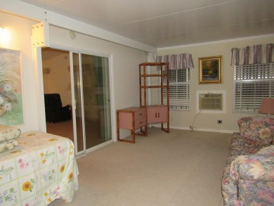 2005 Palm Harbor mobile home with a large (12x20) Florida room on Spanish Lakes Golf Village in Florida - for sale on GolfHomes.com, golf home, golf lot