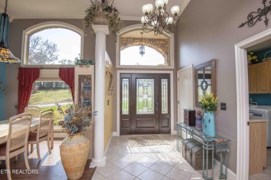 Golf course views, sun-filled rooms, and a massive 23x43 4-car on Tellico Village -The Links At Kahite Golf Course in Tennessee - for sale on GolfHomes.com, golf home, golf lot