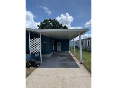 2 bed | 2 bath | 864 sq ft - Handyman's Special in Highly on Lake Henry Golf Club in Florida - for sale on GolfHomes.com, golf home, golf lot