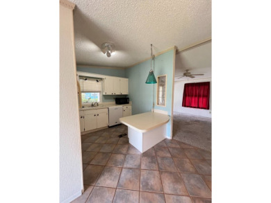 2 bed | 2 bath | 864 sq ft - Handyman's Special in Highly on Lake Henry Golf Club in Florida - for sale on GolfHomes.com, golf home, golf lot