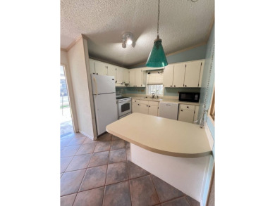 2 bed | 2 bath | 864 sq ft - Handyman's Special in Highly on Lake Henry Golf Club in Florida - for sale on GolfHomes.com, golf home, golf lot