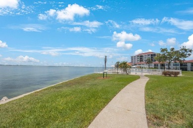 Experience Waterfront Living in this Charming 2-Bed, 2-Bath on Isla Del Sol Yacht and Country Club in Florida - for sale on GolfHomes.com, golf home, golf lot