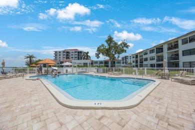 Experience Waterfront Living in this Charming 2-Bed, 2-Bath on Isla Del Sol Yacht and Country Club in Florida - for sale on GolfHomes.com, golf home, golf lot