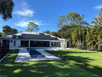 This beautifully redesigned home is nestled on an oversized lot on Imperial Golf Club in Florida - for sale on GolfHomes.com, golf home, golf lot