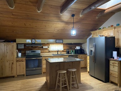 This authentic log cabin is priced to sell! Includes the on Holly Lake Ranch Golf Club in Texas - for sale on GolfHomes.com, golf home, golf lot