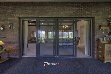 Step into this charming, expansive one-story brick home nestled on Olive Glenn Golf and Country Club in Wyoming - for sale on GolfHomes.com, golf home, golf lot