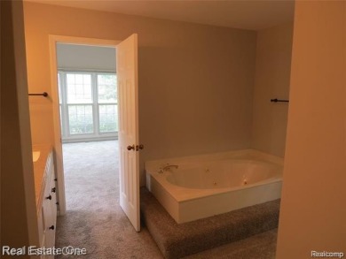 Welcome to this beautiful end unit condo in Country Club Village on Bushwood Golf Club in Michigan - for sale on GolfHomes.com, golf home, golf lot