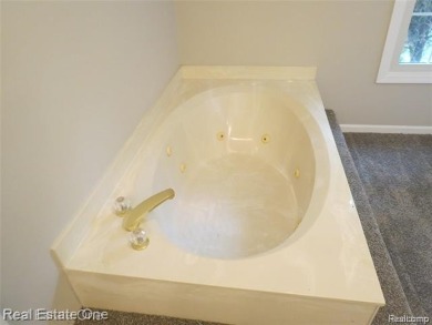 Welcome to this beautiful end unit condo in Country Club Village on Bushwood Golf Club in Michigan - for sale on GolfHomes.com, golf home, golf lot