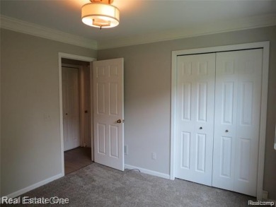 Welcome to this beautiful end unit condo in Country Club Village on Bushwood Golf Club in Michigan - for sale on GolfHomes.com, golf home, golf lot