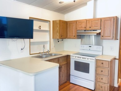 Welcome to your peaceful getaway! Located in The Holiday Out RV on Lake Tansi Village Country Club in Tennessee - for sale on GolfHomes.com, golf home, golf lot
