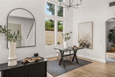 Nestled in a secure gated community within walking distance to on Tustin Ranch Golf Club in California - for sale on GolfHomes.com, golf home, golf lot