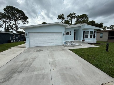 This beautifully updated stucco home is located only steps to on Del Tura Golf and Country Club in Florida - for sale on GolfHomes.com, golf home, golf lot